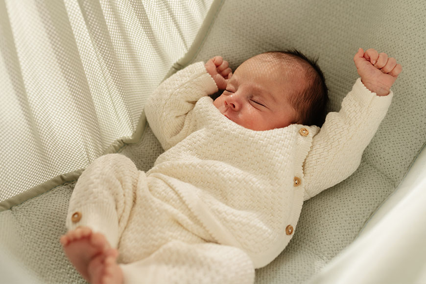 Baby stretches in the hammock